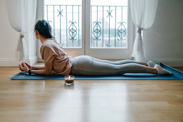 A woman lying on a yoga mat