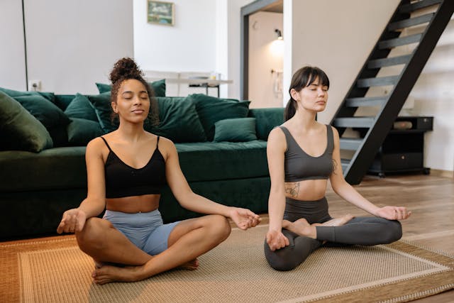 A group of women meditating in a living room