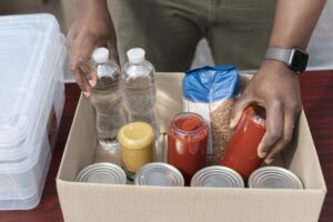 Man loading box with food donations