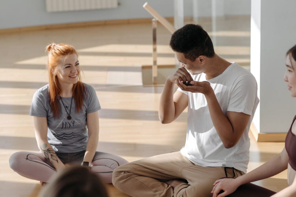 a group of adults enjoying a yoga session in a bright, sunlit room